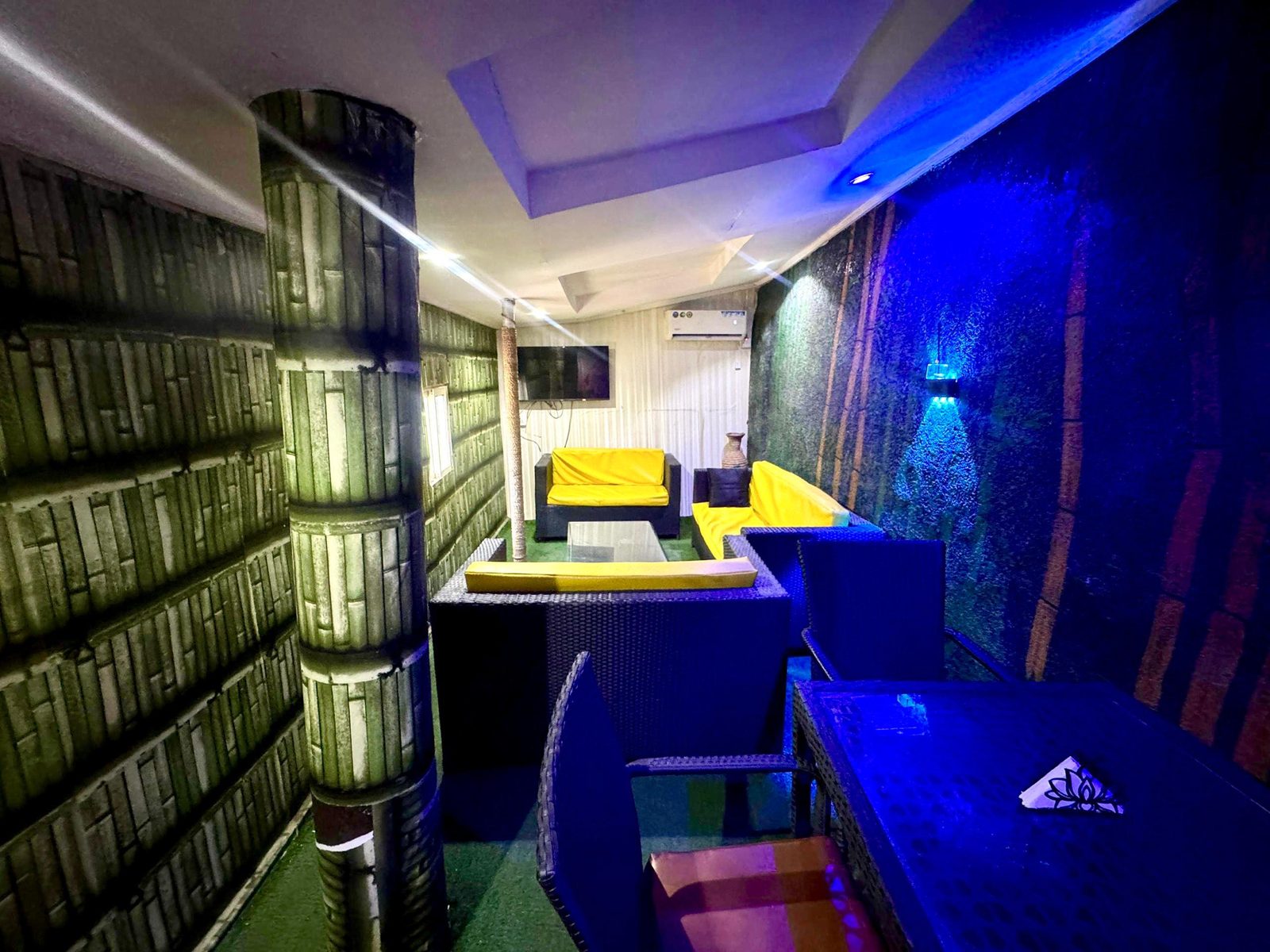 Bamboo Cafe interior with bamboo walls, yellow leather sofas and mood lighting