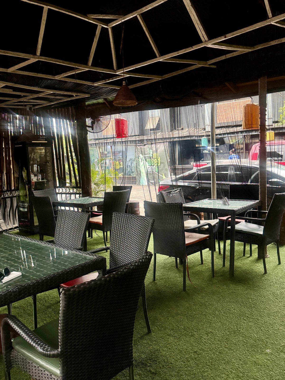 Rattan seating on green turf in the Main Yard