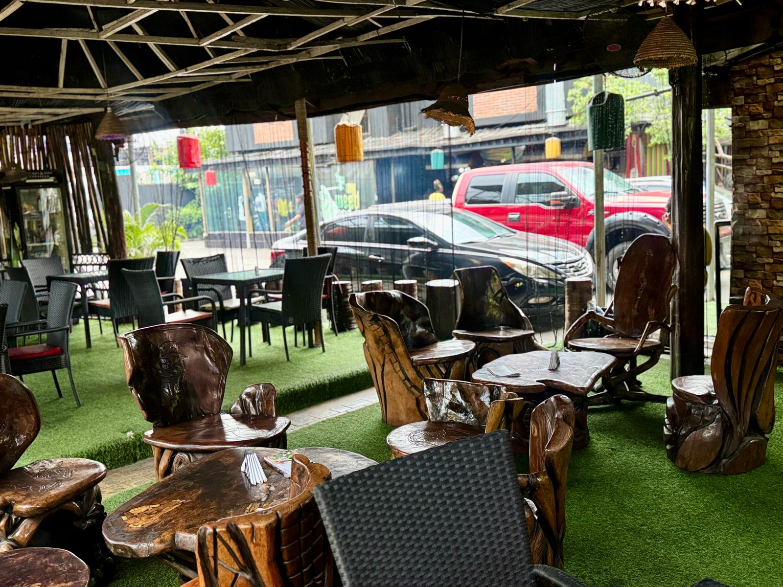 Hand-carved wooden chairs in the Main Yard at Kulture Yard