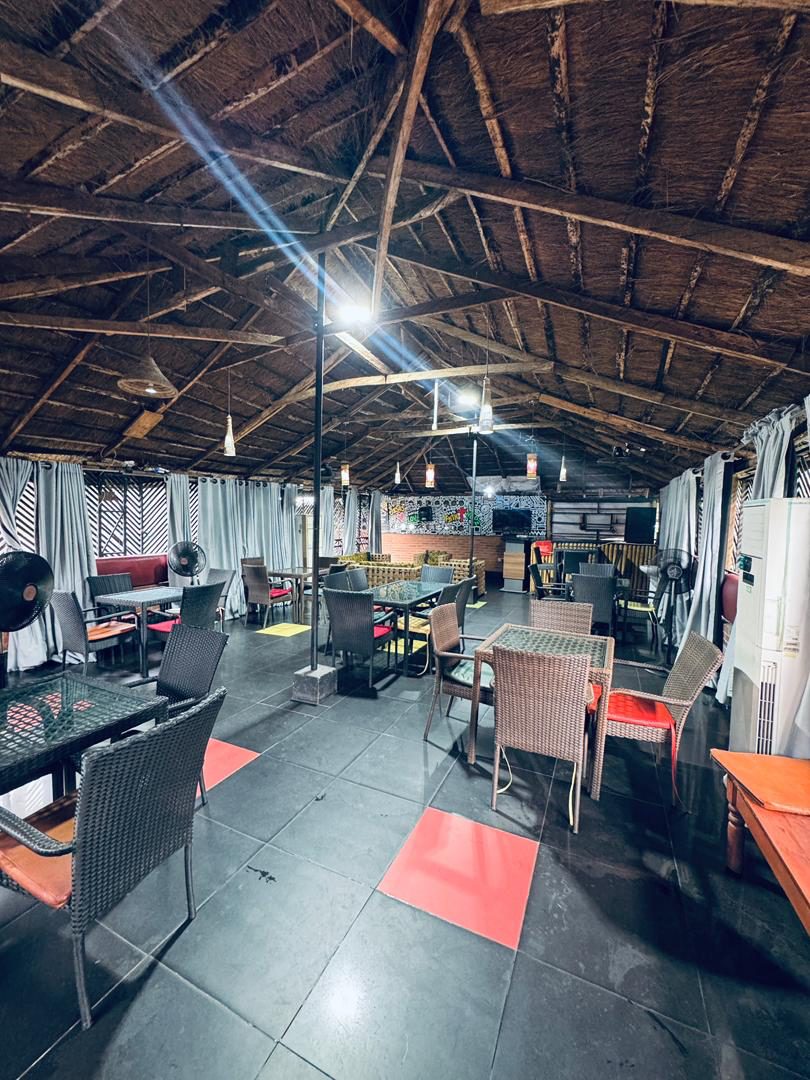 Rooftop lounge at Kulture Yard with thatched roof and seating